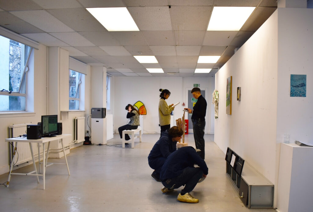 Visitors at the exhibition looking at the works.