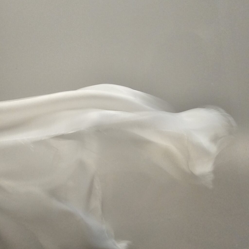 I photographed this moment to capture fabric caught in the breath of the wind.