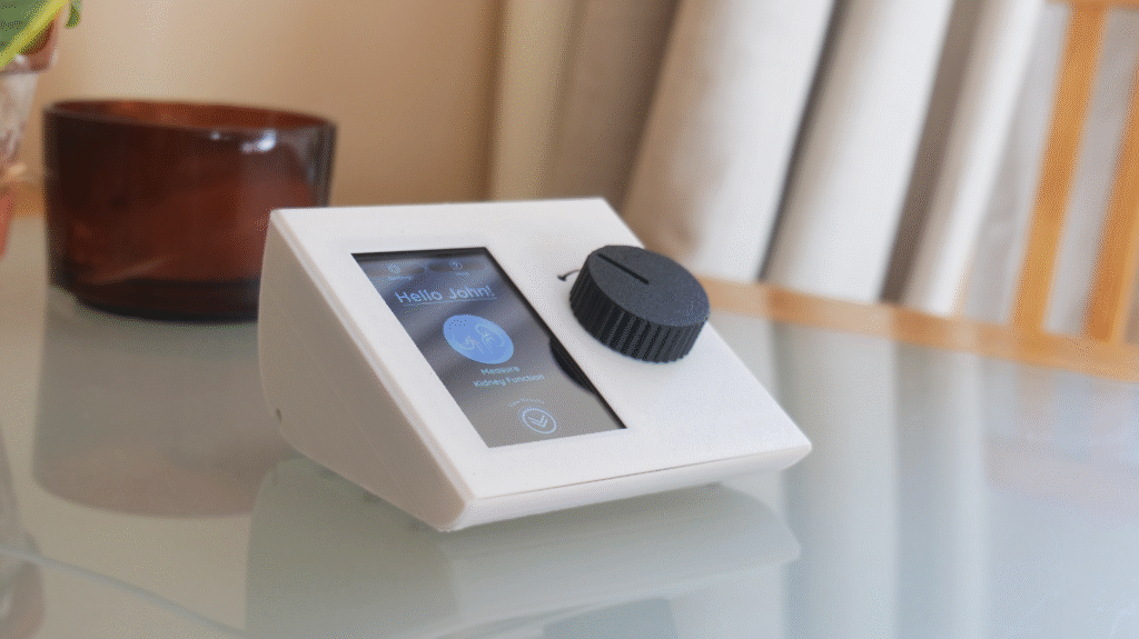 A compact table top device with a clear touchscreen and a large twist cap. It guides you through each step and gives a simple eGFR update for calm reassurance between blood tests.