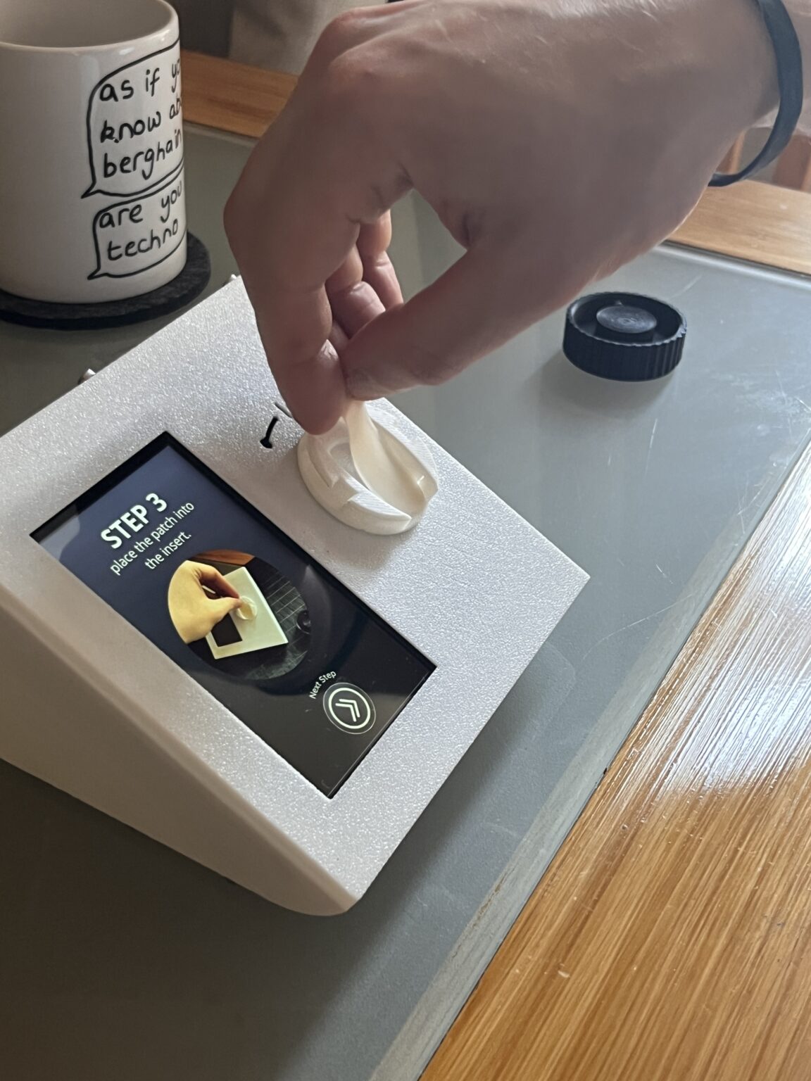 Soft hydrogel patches and the insert tray of the hub. After a day of wear, the patch goes in and the twist action expresses the sample for analysis.
